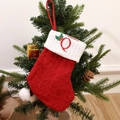 Red knitted Christmas stocking with white cuff and embroidered letter Q on festive tree - Letter Q