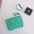 Macro detail of cotton storage bag with green oval patterns and a simple wish label - Green Geometric