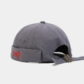 Close-up of the metal adjustable strap and red bow embroidery on this dark grey miki hat - Fog Blue
