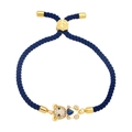 Detailed shot of dark blue woven rope bracelet with gold bear and blue heart gem - Blue