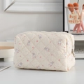 Cream quilted cosmetic bag featuring cute bunny prints and floral patterns for travel storage - Little Rabbit