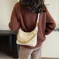 White quilted leather hobo bag with gold chain strap shown on model shoulder - Off White