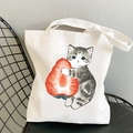 Kawaii white canvas tote bag featuring cute cat and strawberry print on mesh chair - Tabby Cat Holding Strawberry