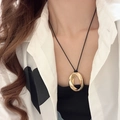 Close-up of minimalist black cord necklace featuring a twisted golden teardrop pendant - 38# Necklace Gold Twisted Oval