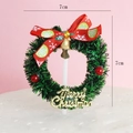 7cm Christmas wreath cake topper with green pine needles, red bow and gold bell - Snowflake Bow Wreath