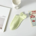 Light green cotton blend no-show sock with heel tab on a minimalist white table - One Size / Green