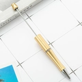 DIY plastic beaded ballpoint pen in metallic brass finish with silver tip and metal rod - Gold