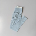 Detail of high waist light blue yoga leggings with ribbed texture and peach lift contour - Baby Blue