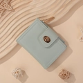 Minimalist light green short wallet with gold clasp and zipper, shown on stylish background - Green