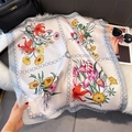 Dettaglio del foulard in seta sintetica con motivi floreali e bordo a catena su pelliccia - Bordo Grigio (Catena Floreale)