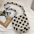 Detail of soft fleece shoulder bag with black polka dots on white textured fabric - White Background Polka Dots