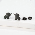 Macro shot of cute black elephant stud earrings with butterfly backs on white stone - Elephant / Black