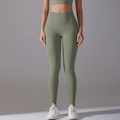 Macro detail of high-waist yoga leggings in olive green with seamless high-stretch fabric - Green-Gray