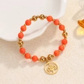 Orange and gold beaded stretch bracelet featuring a cutout tree of life pendant - Orange Beads-Gold Hollow Tree of Life Charm