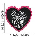 Macro shot of heart-shaped embroidered patch with pink border and white social club text - Heart Pink Black SOCIAL ANXIETY Slogan (132-11)
