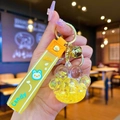 Yellow cat paw liquid quicksand keychain with gold bell and translucent wrist strap - Yellow Luminous Bubble Bead Cat Paw