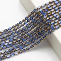 Close-up of 4x6mm blue glass rice beads and gold-edged spacer beads for DIY jewelry - 4x6mm Gold Edged Seed Beads approx. 48pcs/Strand / Blue Gold Edge