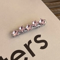 Detailed close-up of a silver hair clip with five pink star-shaped crystals - Star Array Bobby Pin