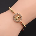 Verstellbares Armband aus Kupfer und Zirkonia mit der Jungfrau von Guadalupe Anhänger - Goldene Kupferperlen + Rotes geflochtenes Seil