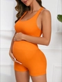 Side view of seamless ribbed maternity yoga set in orange with racerback top and shorts - S / Orange
