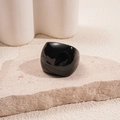 Detailed view of the wide black resin square ring displayed on a stone plinth - Black