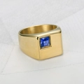 Detail of a gold-toned men's signet ring featuring a square blue sapphire-style stone. - Size 7 / Gold Blue Resin