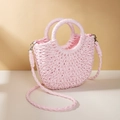 Close-up of pink crescent straw woven handbag with matching rope shoulder strap - Pink