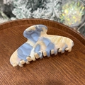 Detail of blue and beige marble acetate hair claw with gold Barrette La France text - Blue White Marble - 8 Teeth