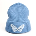 Close-up of light blue ribbed knit beanie featuring a white butterfly jacquard pattern - One Size (Elastic) / Light Blue