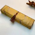 Vintage silk jewelry box with gold and purple wave patterns and a brown tassel finish - Long Necklace Box