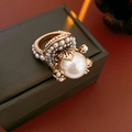 Macro shot of vintage pearl flower ring featuring a large white pearl and gold metal finish - Gold-White