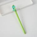 Green pen with dinosaur cartoon cap featuring a smooth ink flow for student writing - Dinosaur