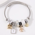 Adjustable stainless steel twisted bracelet with gold heart and crystal bear charms - White