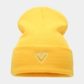 Detailed close-up of bright yellow knit beanie with silver heart embroidery on cuff - M (56-58cm) / Yellow