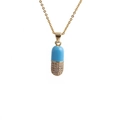 Detail of blue and gold pill-shaped capsule pendant with micro-pave cubic zirconia - O-chain / Blue