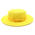 Close-up of yellow boater hat featuring fine woven texture and decorative ribbon bow - Yellow
