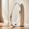 Minimalist silver-tone titanium bangle featuring baguette-cut channel-set zirconias - Baguette Stone (44-E-1) / Steel