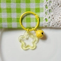 Yellow acrylic star keychain with matching bell and metal ring on white ceramic plate - Transparent Yellow