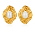 Detailed view of vintage gold swirl earrings with inlaid pearls on a white background - White
