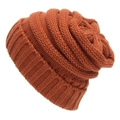 Detail of warm orange knit beanie showing ribbed cuff and wave texture on white backdrop - One Size / Rust red