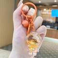 Cute astronaut liquid quicksand keychain charm with orange glitter and matching bell - Small Quicksand Astronaut - Orange