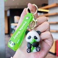 Detail of cute panda keychain with bamboo and Panda Baby green silicone strap - Gen 1 Holding Bamboo