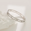 Detailed close-up of silver steel bangle with double-row zircon inlay and Roman numerals - Steel Color Male Style