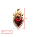 Macro view of gold heart pendant with red enamel, gems and 31mm x 15.5mm dimensions - Flaming Heart