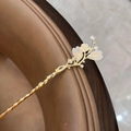 Elegant gold vintage hair pin with cream flowers and pearls on a brown leather surface - Peach Blossom Hairpin - White
