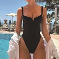 Detail of black one-piece swimsuit with thick straps and high-cut leg by a pool - Pure Black