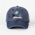 Close-up of multicolored dragon and book embroidery on navy washed denim baseball cap - One Size / Navy Blue