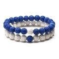 Detail shot of blue and white volcanic lava stone couple bracelets with porous texture - Blue