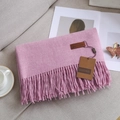 Pink cashmere-feel scarf with elegant fringes and brand label on a soft surface - Melange Purple Pink