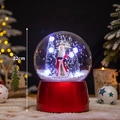 Christmas musical snow globe with Santa and trees on red base, 22cm tall decoration - Snowing Globe Santa